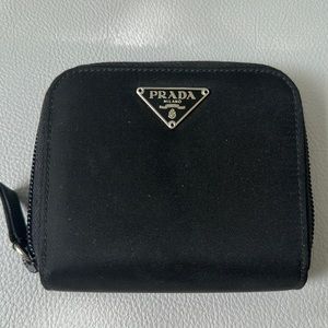 Prada wallet holds 8 cards, bills, and coins.